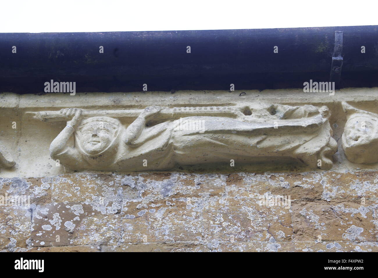 Carving on the Corbel table around the chancel of Hanwell Church, Oxfordshire. Oxford School of Stone Masons Stock Photo