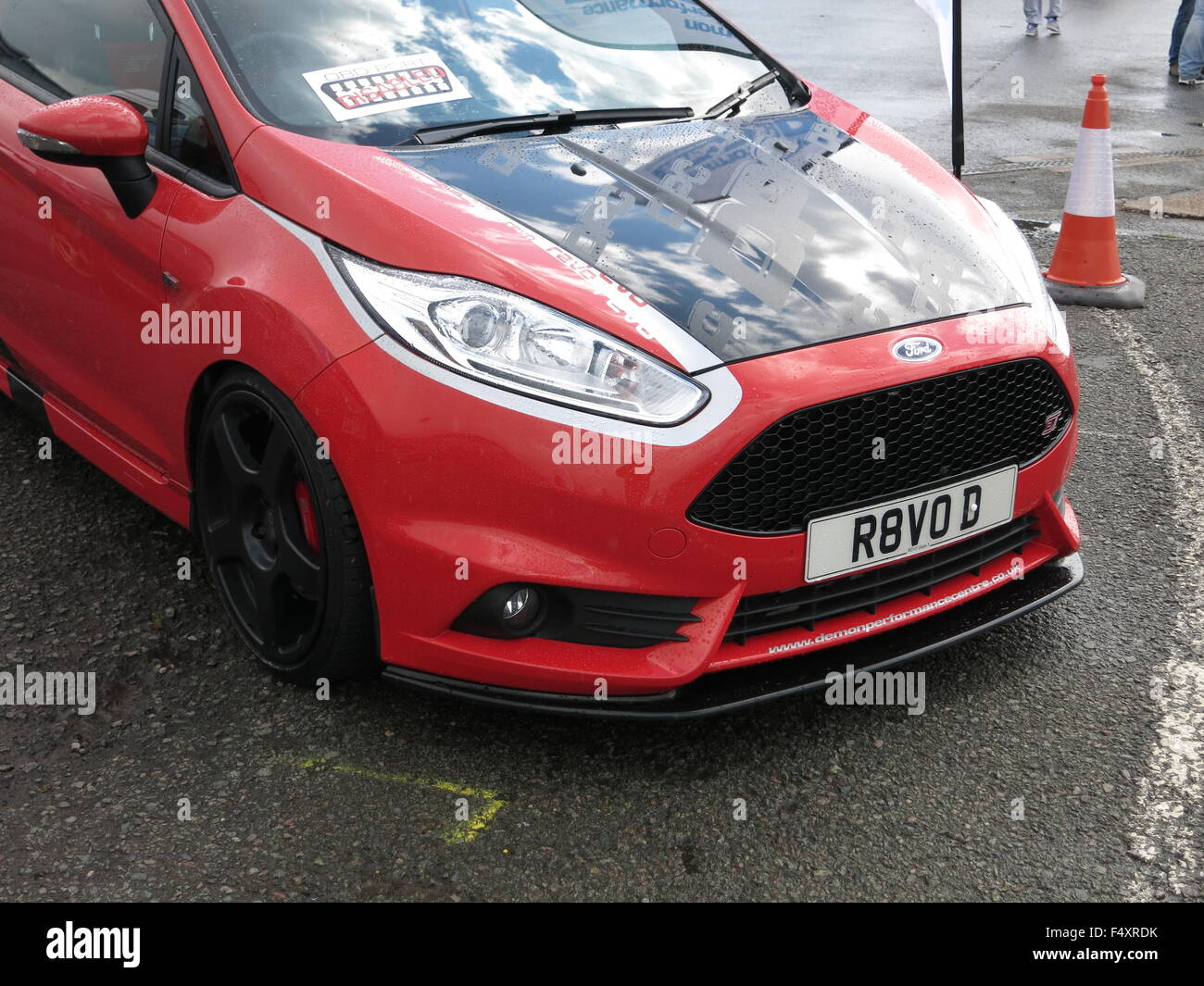 Ford Fiesta Road Car modified - in race red paintwork - with carbon fibre black bonnet and lower spoiler and aftermarket alloy wheels - on display at donnington circuit Stock Photo - Alamy