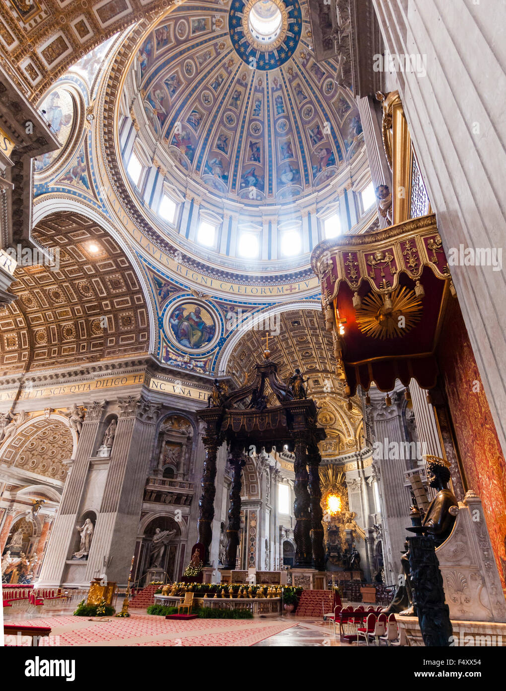 Interior of the Papal Basilica of St. Peter, Vatican: chancel with Bernini's baldacchino altar underneath the main dome. Stock Photo