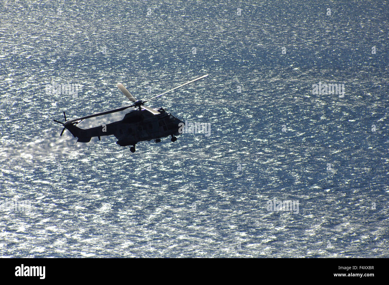 Hellenic Air Force SAR helicopter, returning to base, after the drill. Stock Photo