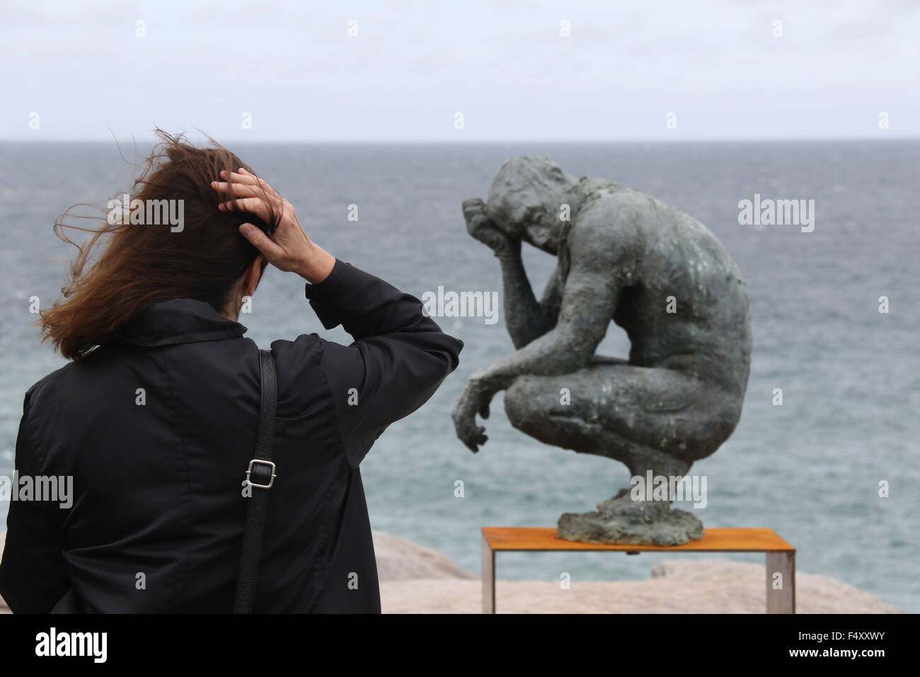 Sculpture no. 83, ‘Crouching man’ by Laurence Edwards from UK at the 19th annual Sculpture by the Sea Bondi. 22 October 2015. Stock Photo