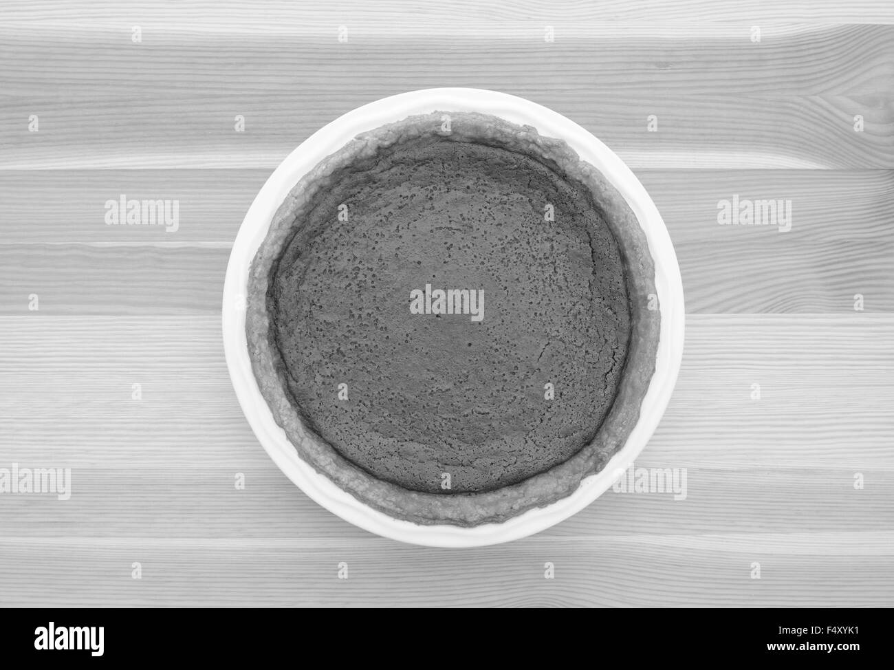 Freshly baked homemade pumpkin pie for Thanksgiving on a kitchen table - monochrome processing Stock Photo
