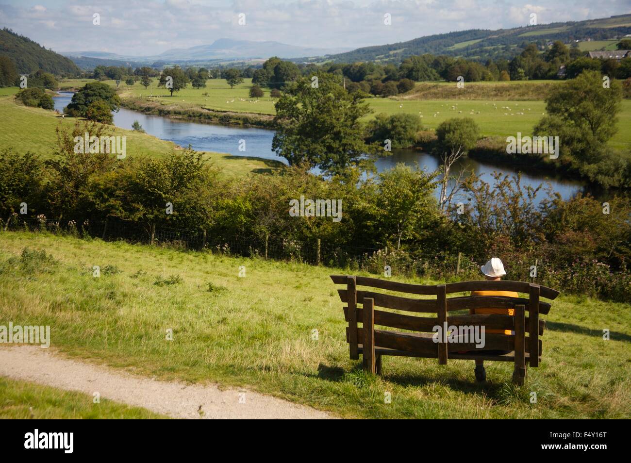 Admiring view of River Lune from Hermitage Fields near Crook O'Lune, Lancashire with the Yorkshire dales in the distance Stock Photo