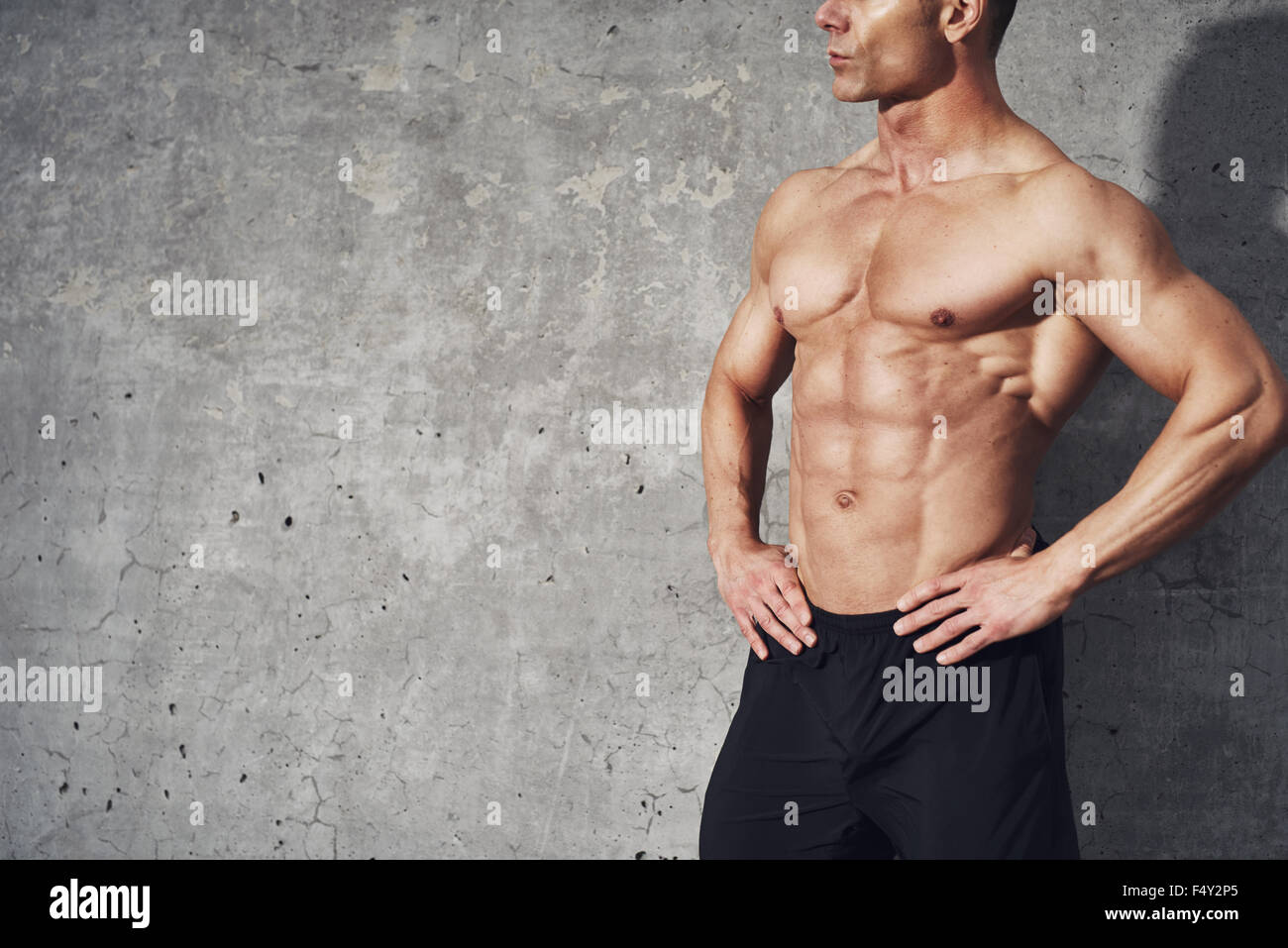 Fitness portrait half body six pack no shirt, fitness concept, room for copyspace, fit and healthy muscular male body with abdom Stock Photo