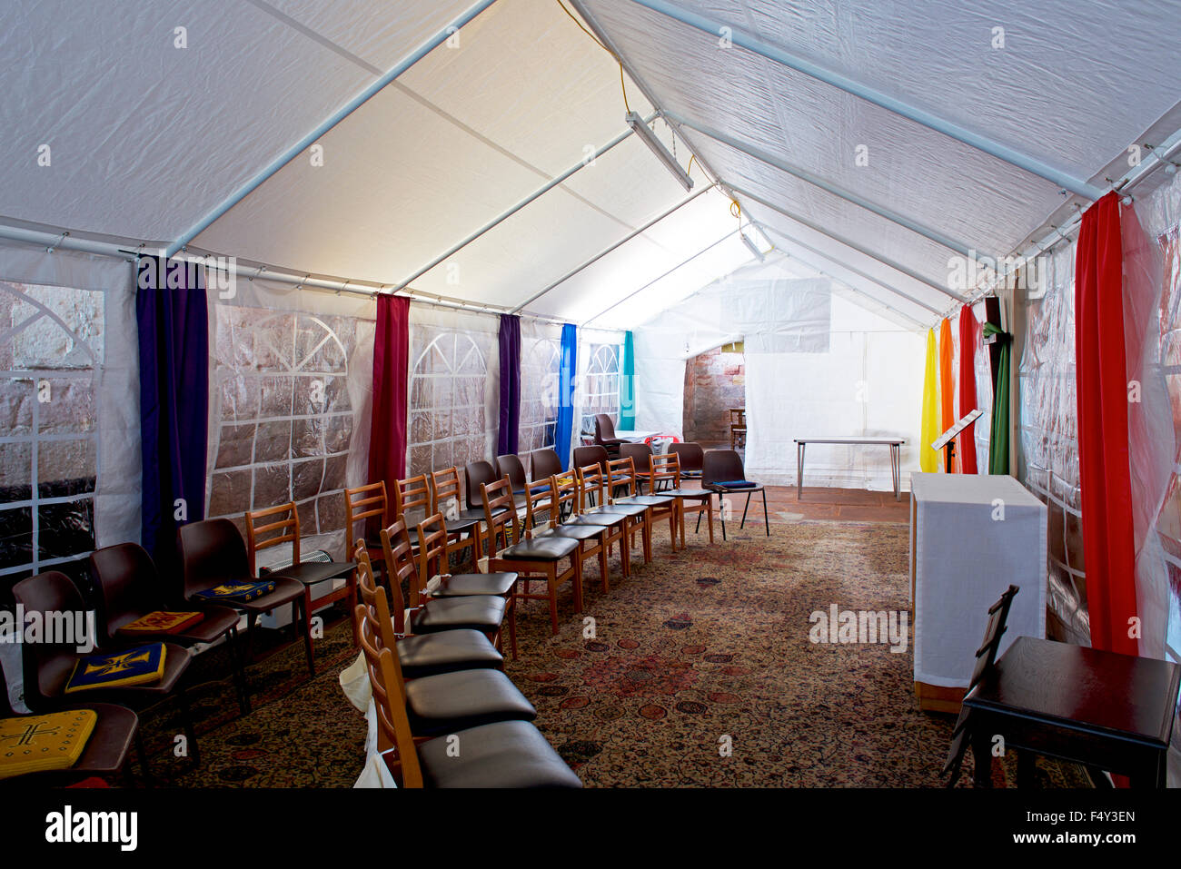 Marquee erected inside St Andrew's Church to keep the small congregation warmer in winter, Greystoke, Cumbria, England UK Stock Photo