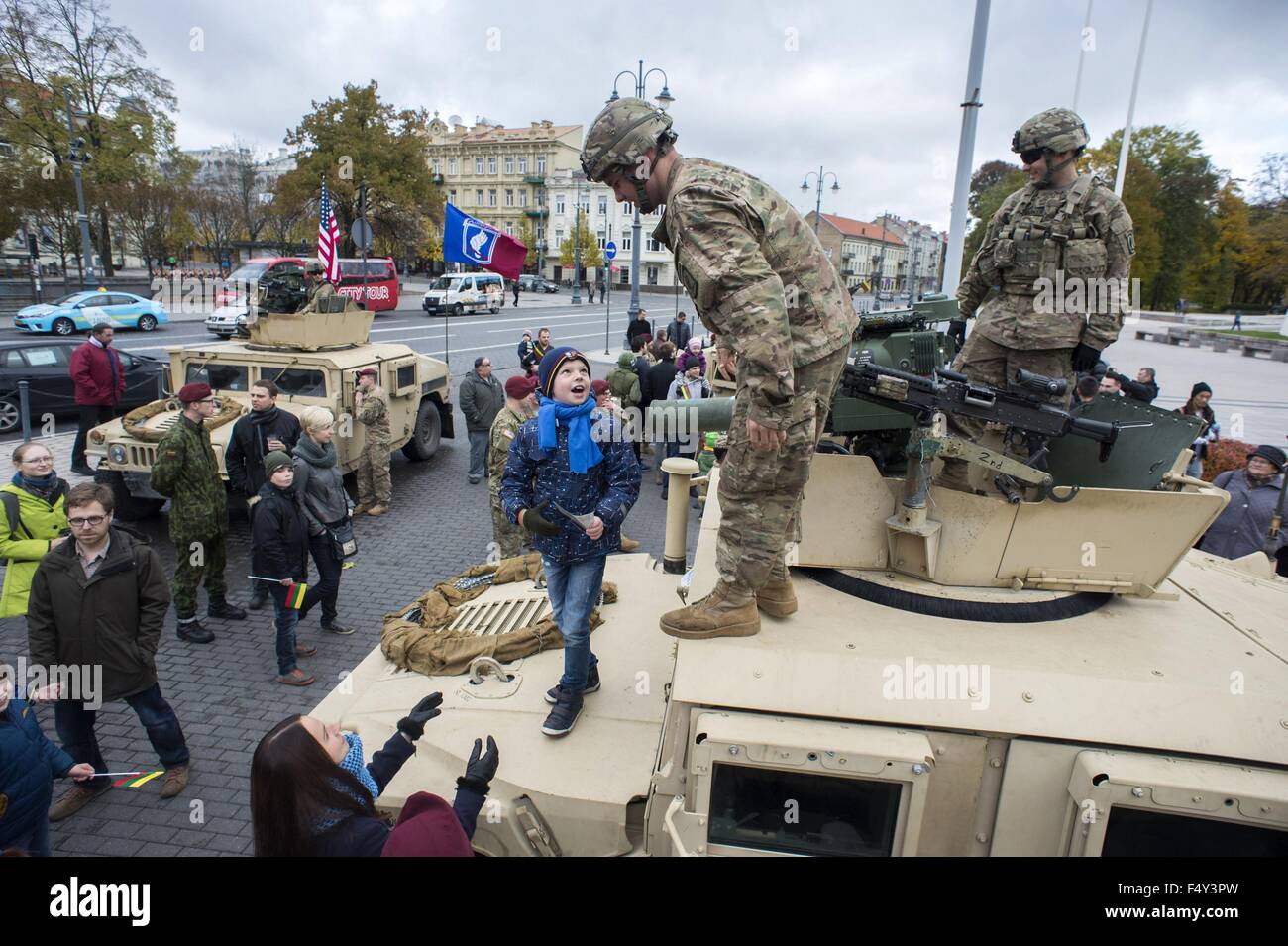 Vilnius, Lithuania. 24th Oct, 2015. A child talks with soldiers from the 173rd Airborne Brigade of the U.S. in Vilnius, Lithuania, Oct. 24, 2015. U.S. started sending rotational forces to Lithuania since spring of 2014, and jointly attended exercises with troops of Lithuania as well as from other NATO allies. Credit:  Alfredas Pliadis/Xinhua/Alamy Live News Stock Photo