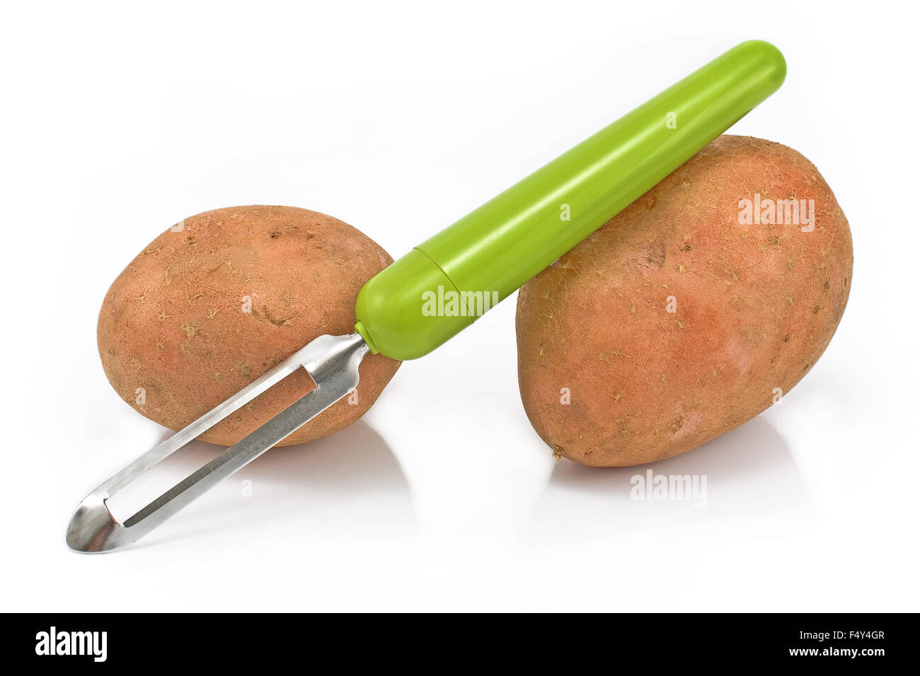 https://c8.alamy.com/comp/F4Y4GR/potatoes-with-vegetable-peeler-on-white-F4Y4GR.jpg
