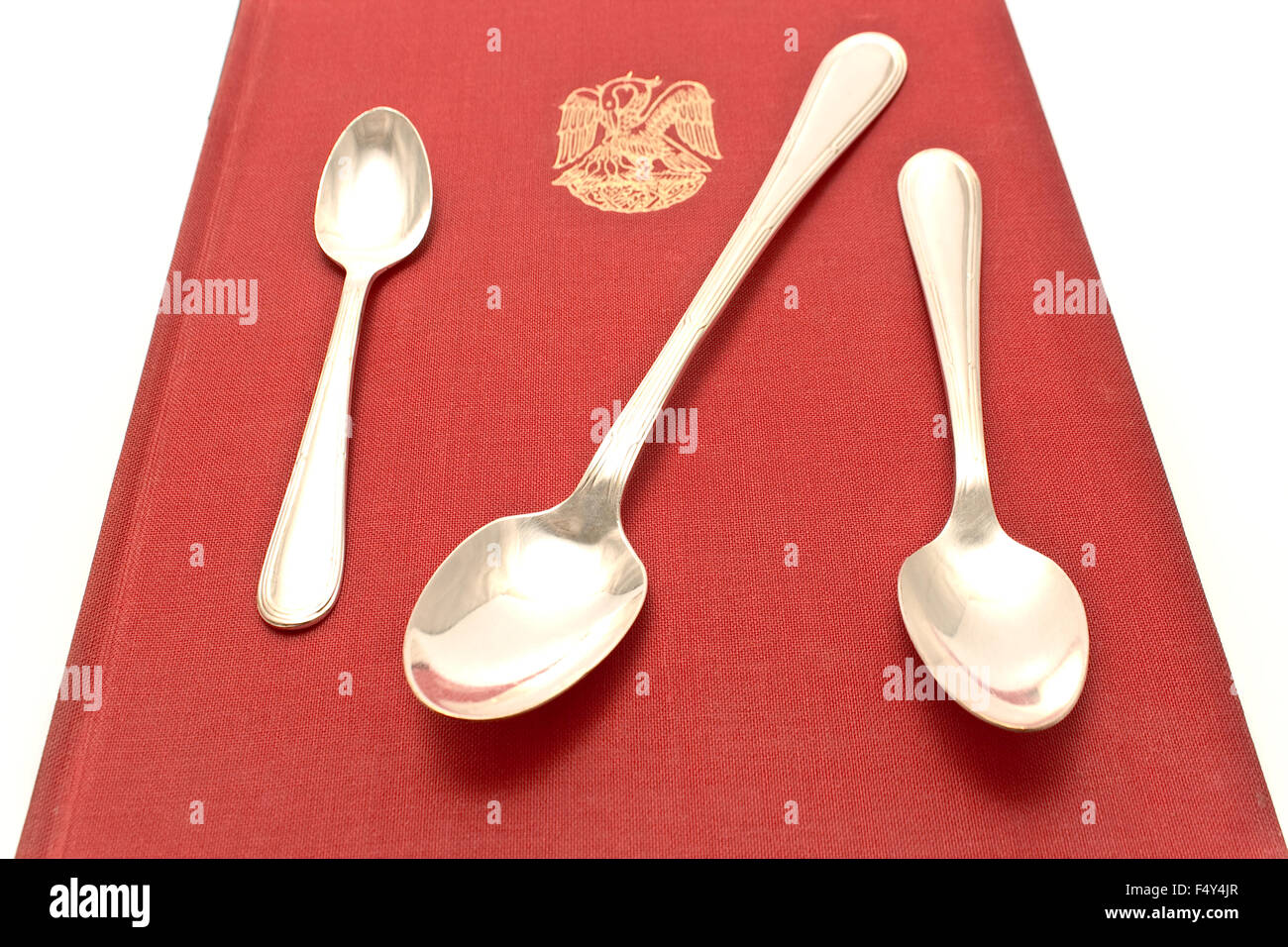 Threes silver spoons on red Stock Photo