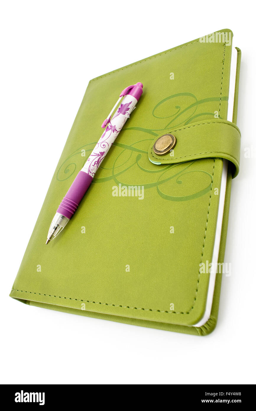 Pen and green notebook isolated on white Stock Photo