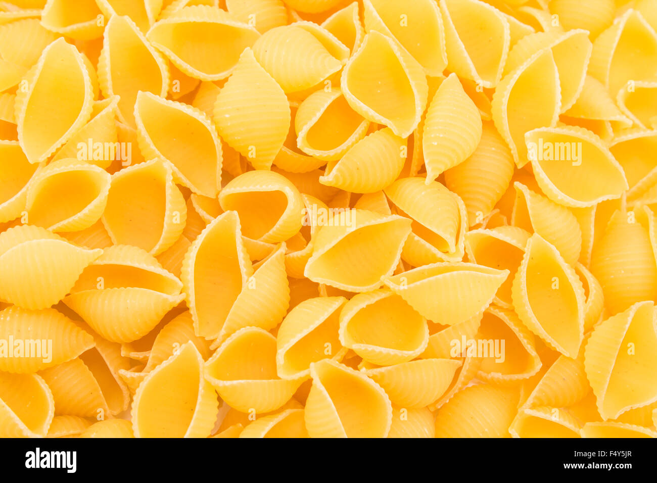 Italian pasta shells in a pile Stock Photo - Alamy