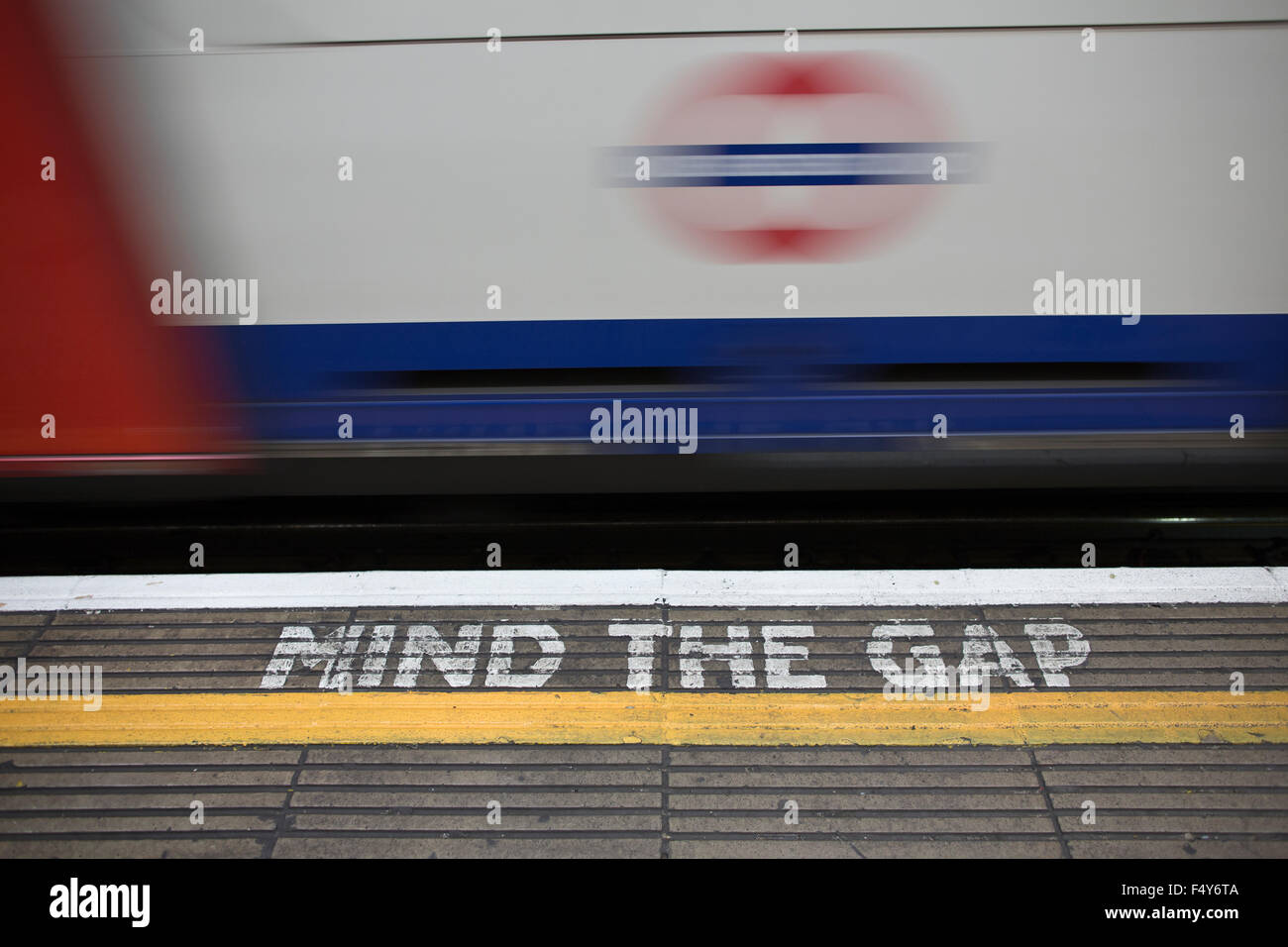 MIND THE GAP visual warning issued to rail passengers alongside the London Underground track, London, UK Stock Photo