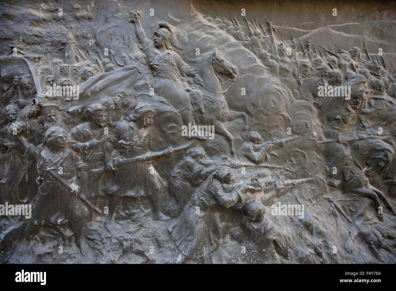 Closeup shot of the Battle of Dervenakia and Theodoros Kolokotronis on his horse depiction, on the base of his monument. Athens Stock Photo
