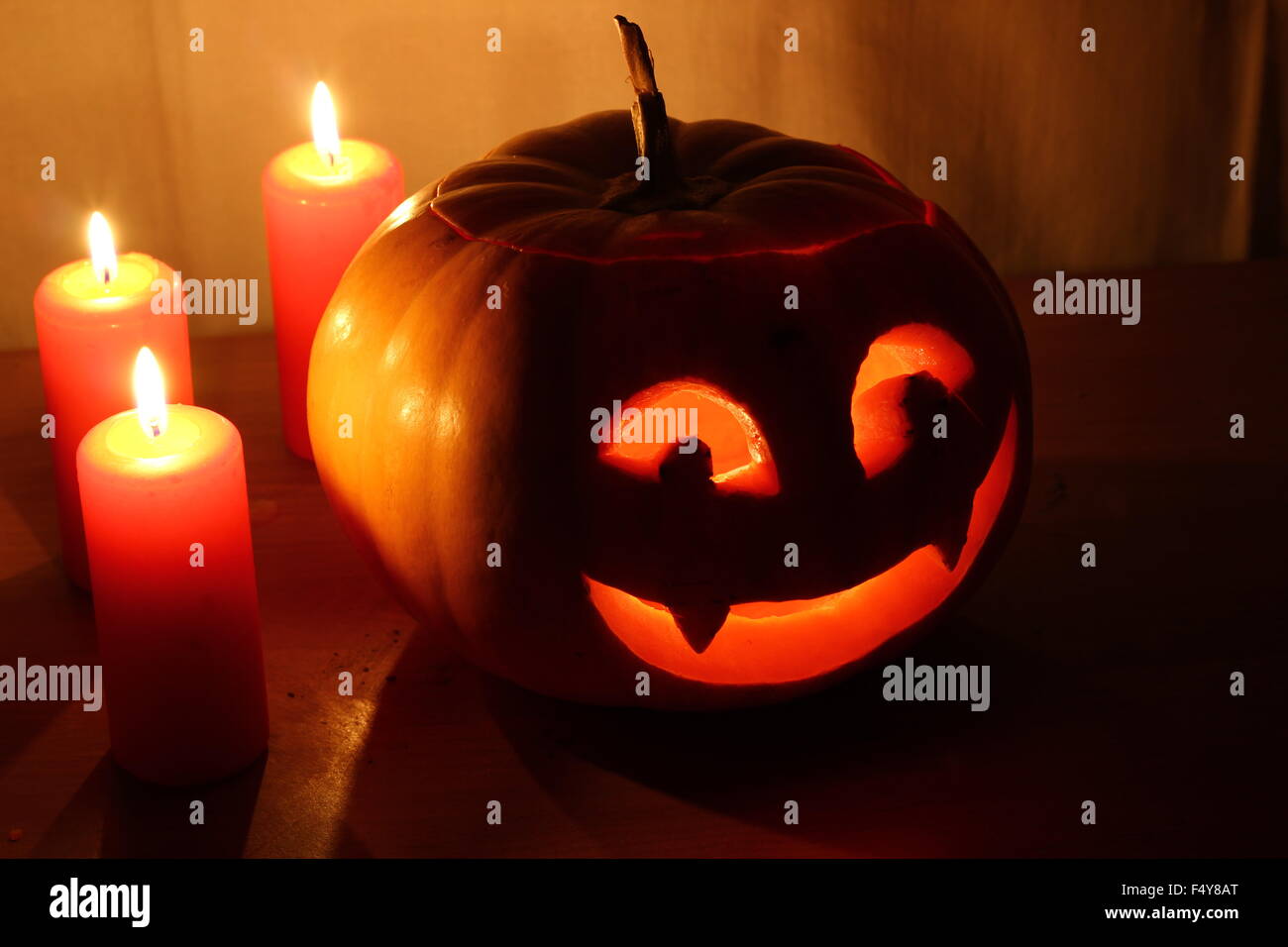 Scary Halloween pumpkin with candles on a dark background Stock Photo