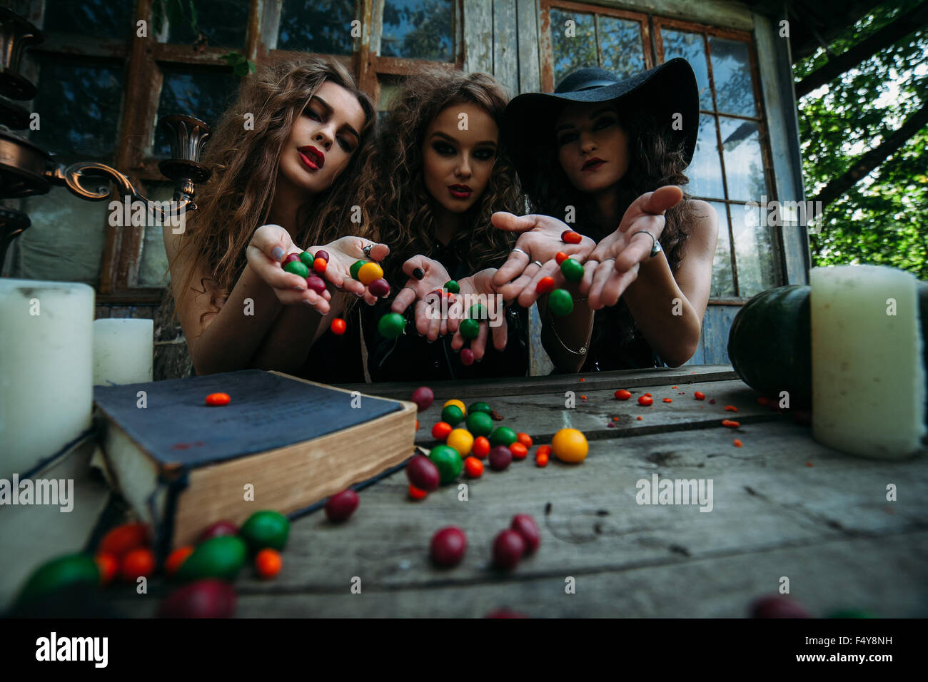 Three vintage witches perform magic ritual Stock Photo - Alamy