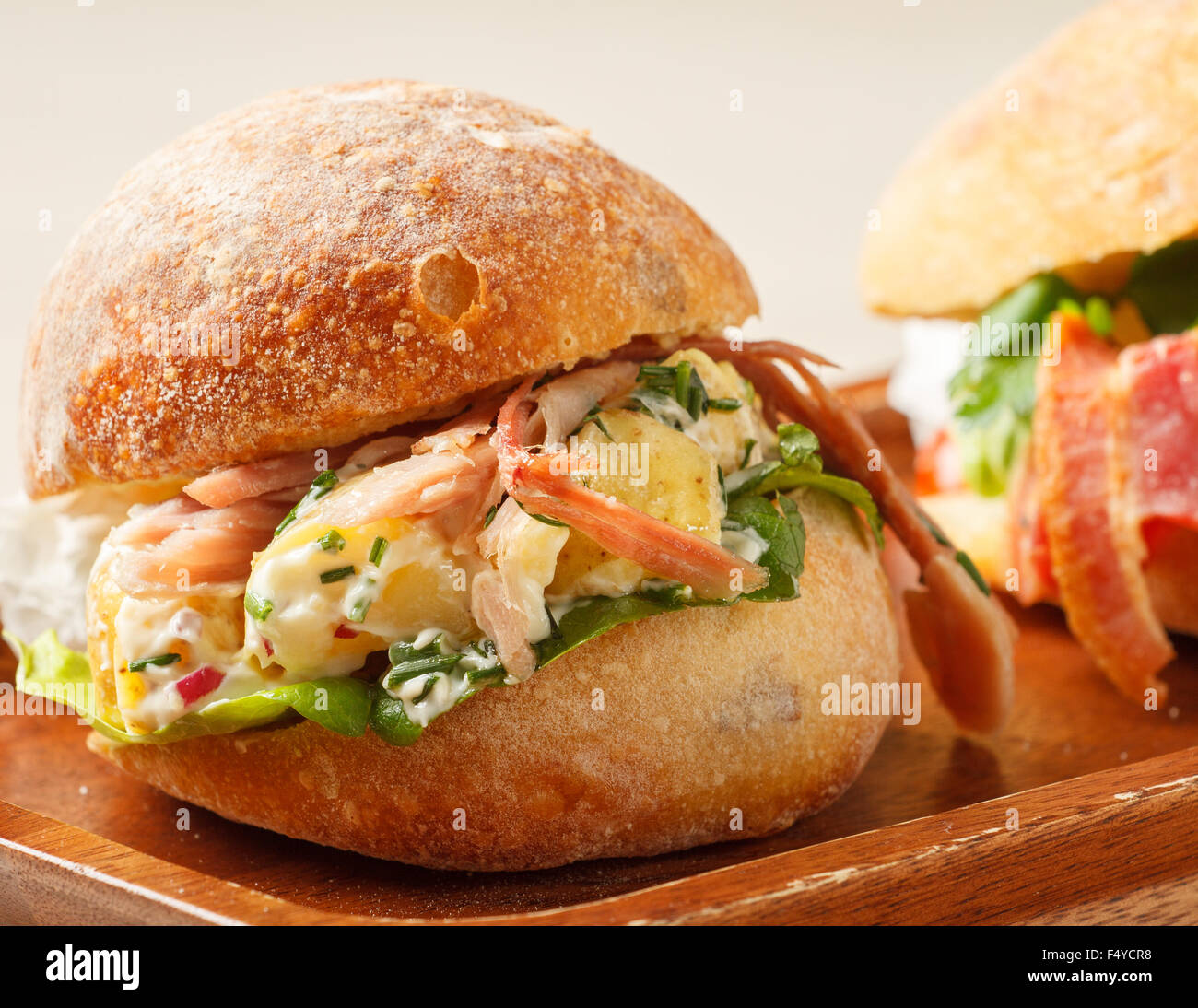 Sandwich In A Bun Made With Bacon And Potato Salad Stock Photo Alamy