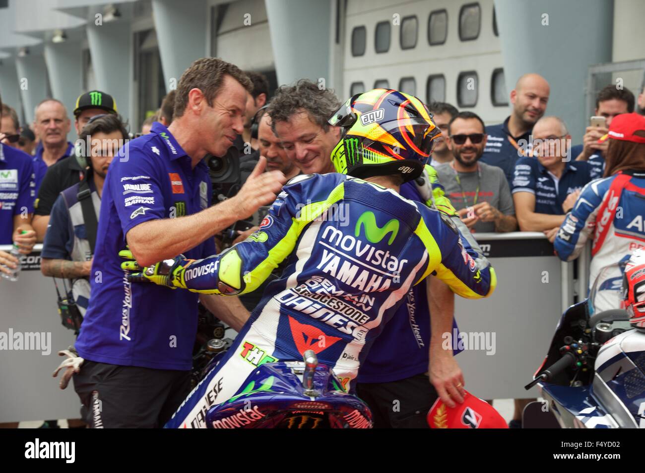 Sepang Circuit, Malaysia. 24th  Oct, 2015. Valentino Rossi is congratulated by his team in the Parc Ferme after qualifying for the Shell Malaysia Motorcycle Grand Prix at Sepang Circuit Stock Photo