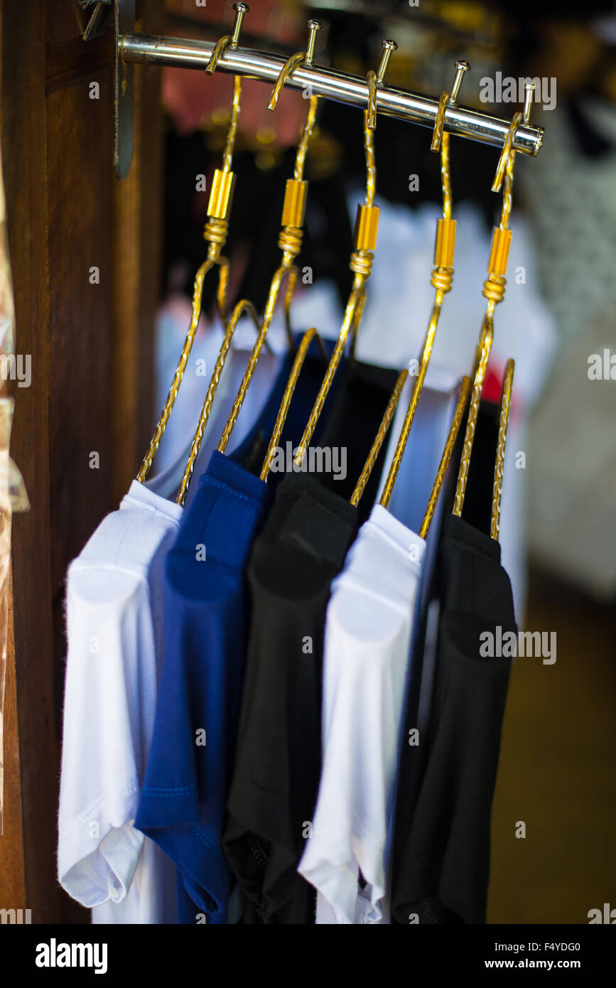 Tshirts hanging on a clothesline in a clothing store Stock Photo Alamy