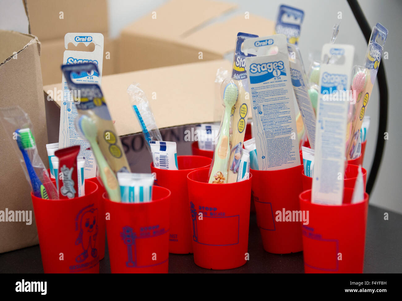Bramsche, Germany. 23rd Oct, 2015. Toothbrushes, toothpaste, and cups ...
