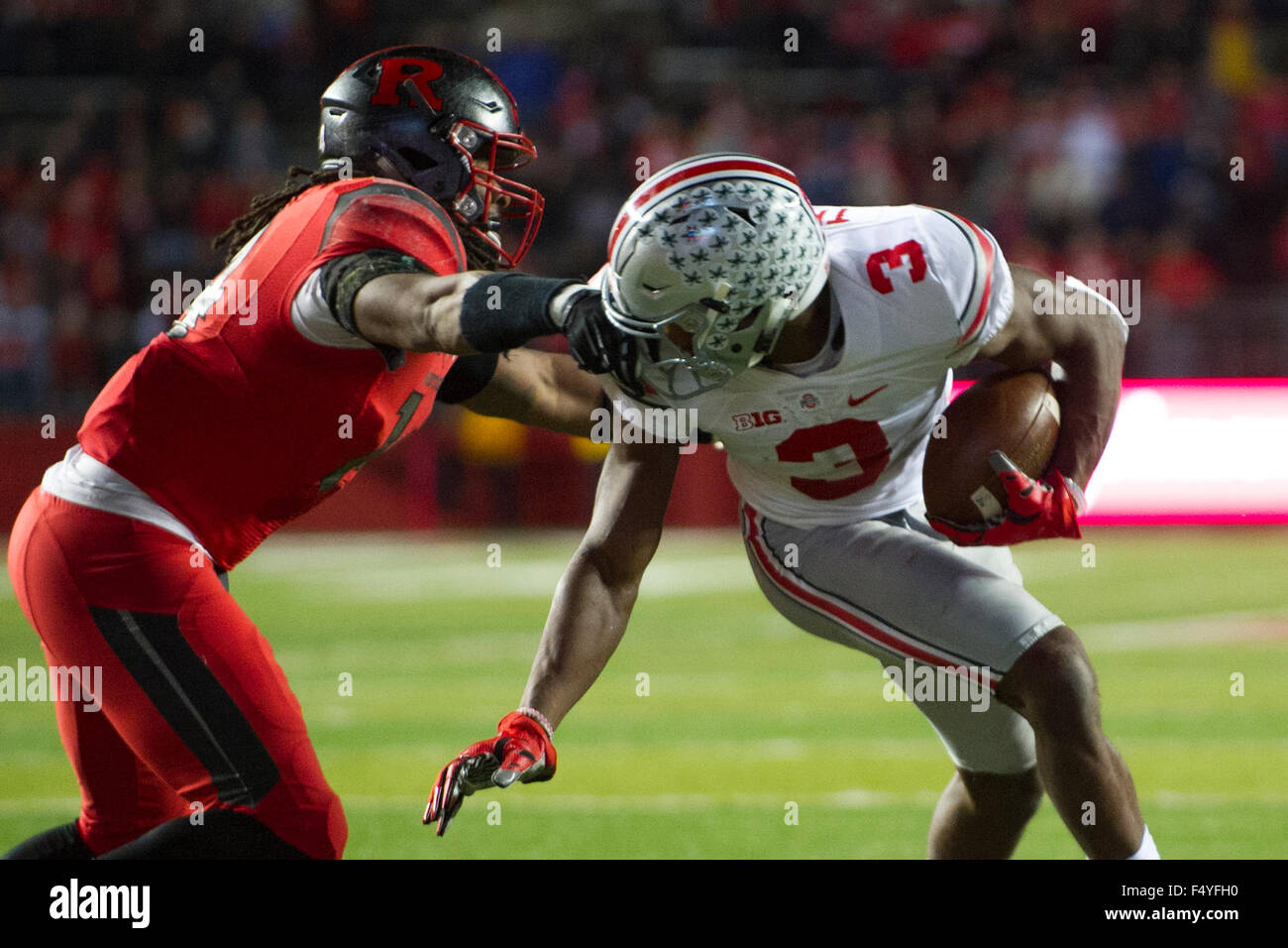 Piscataway, NJ, USA. 24th Oct, 2015. Rutgers Scarlet Knights linebacker Taiwan Lewis (14) grabs Ohio State Buckeyes wide receiver Michael Thomas (3) by the face mask during the game between The Ohio State Buckeyes and Rutgers Scarlet Knights at Highpoint Solutions Stadium in Piscataway, NJ. The Ohio State Buckeyes defeat The Rutgers Scarlet Knights 49-7. Mandatory Credit: Kostas Lymperopoulos/CSM, Credit:  csm/Alamy Live News Stock Photo