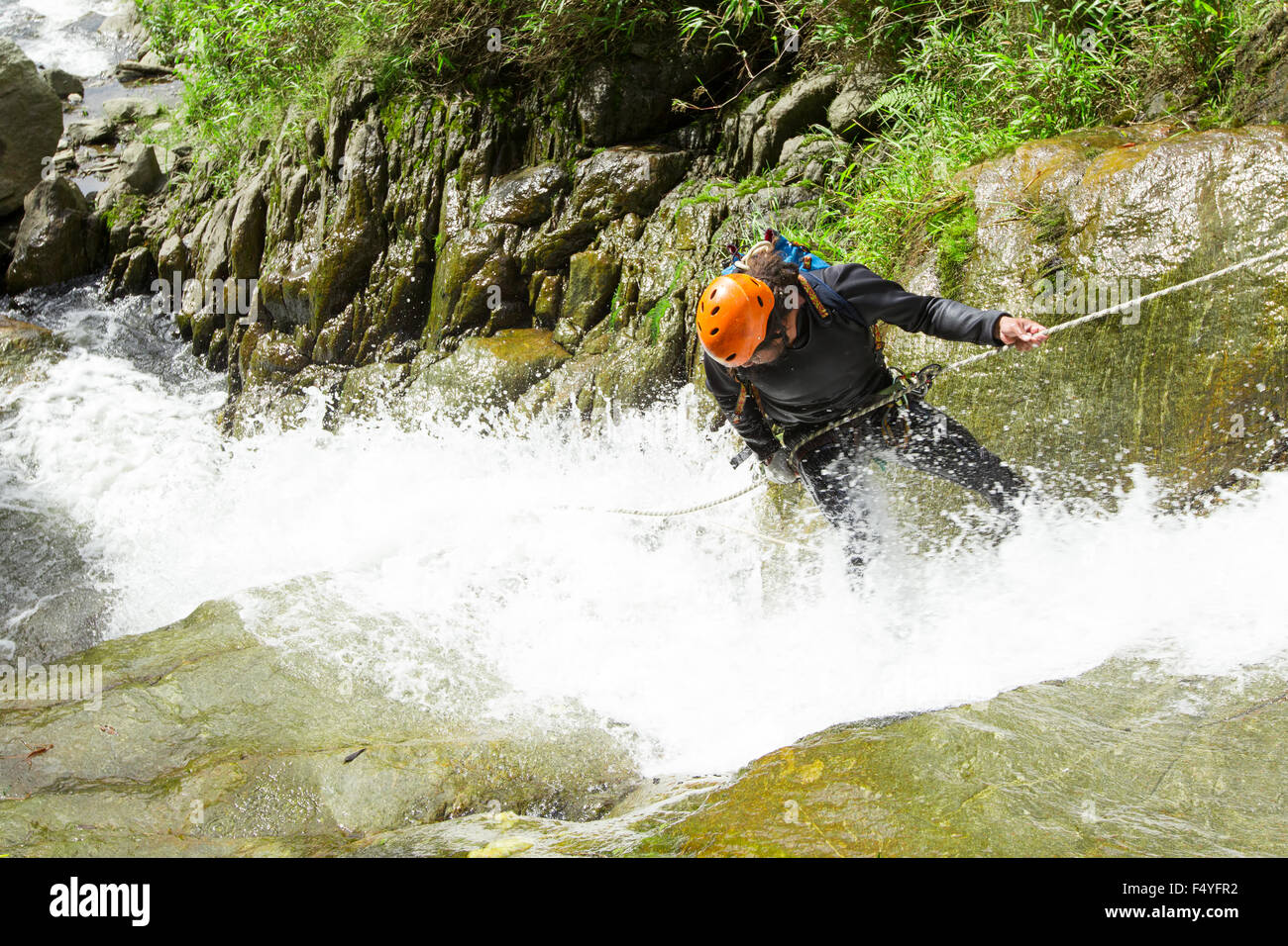Canyoning Guid Trying Out A News Route In Chama Waterfall Banos De Agua Santa Ecuador Stock Photo