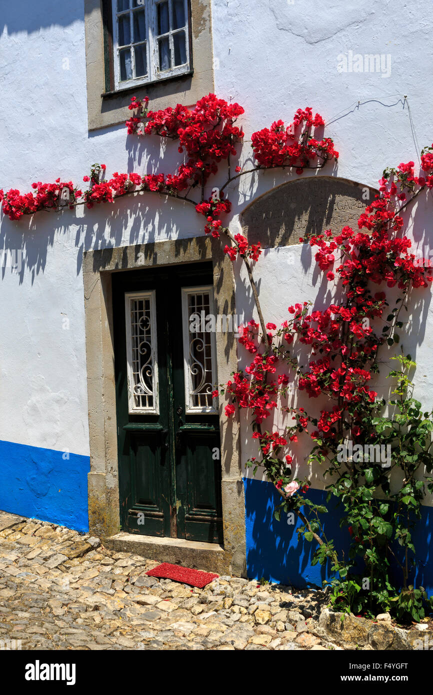 White walled house with bougainvillea framed doorway Obidos Portugal Stock Photo