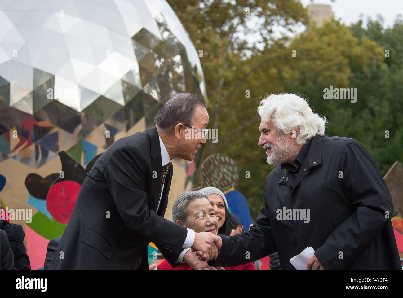 New York, United States. 24th Oct, 2015. Secretary-General Ban Ki-moon (left) shakes hands with Cristobal Gabarron (right). To commemorate the 70th anniversary of the United Nations Charter, United Nations and New York City officials joined to inaugurate the opening of Cristobal Gabarron's sculptural installation titled 'Enlightened Universe:' a reflective metal sphere surrounded by an overlapping ring of brightly-colored life-size figures holding hands. © Albin Lohr-Jones/Pacific Press/Alamy Live News Stock Photo