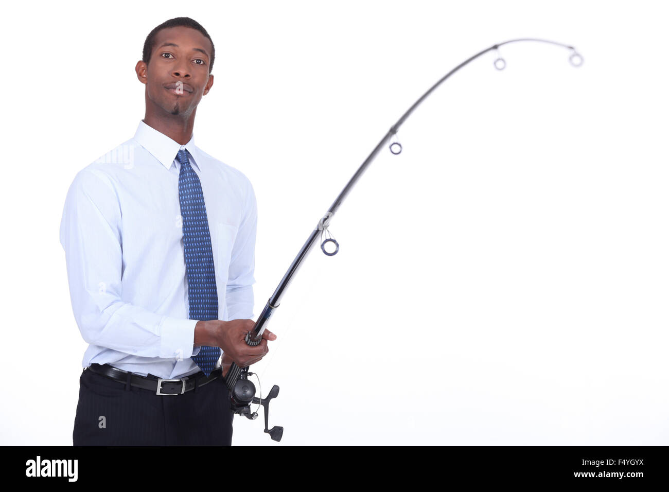 Man in a shirt and tie using a fishing rod Stock Photo - Alamy