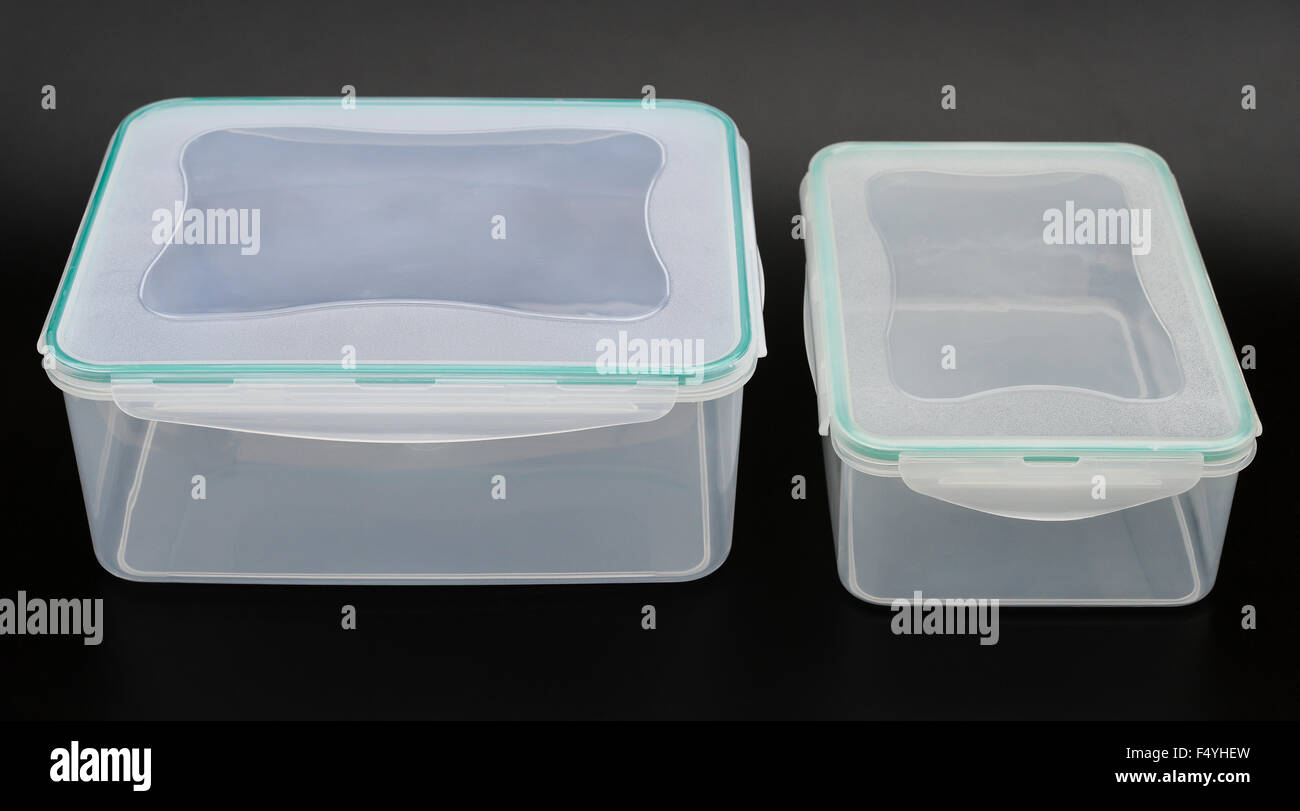 translucent storage boxes on a black background Stock Photo