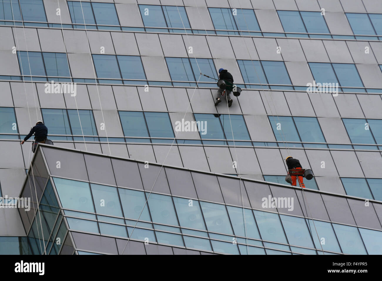 Workers are cleaning windows outside office building, Warsaw, Poland