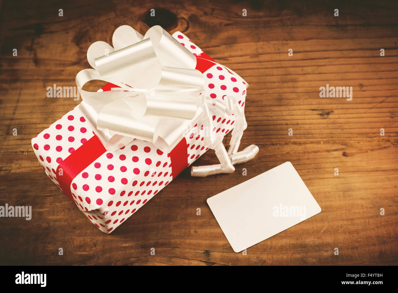 Christmas gift in box and blank greeting card as copy space, retro toned, selective focus Stock Photo