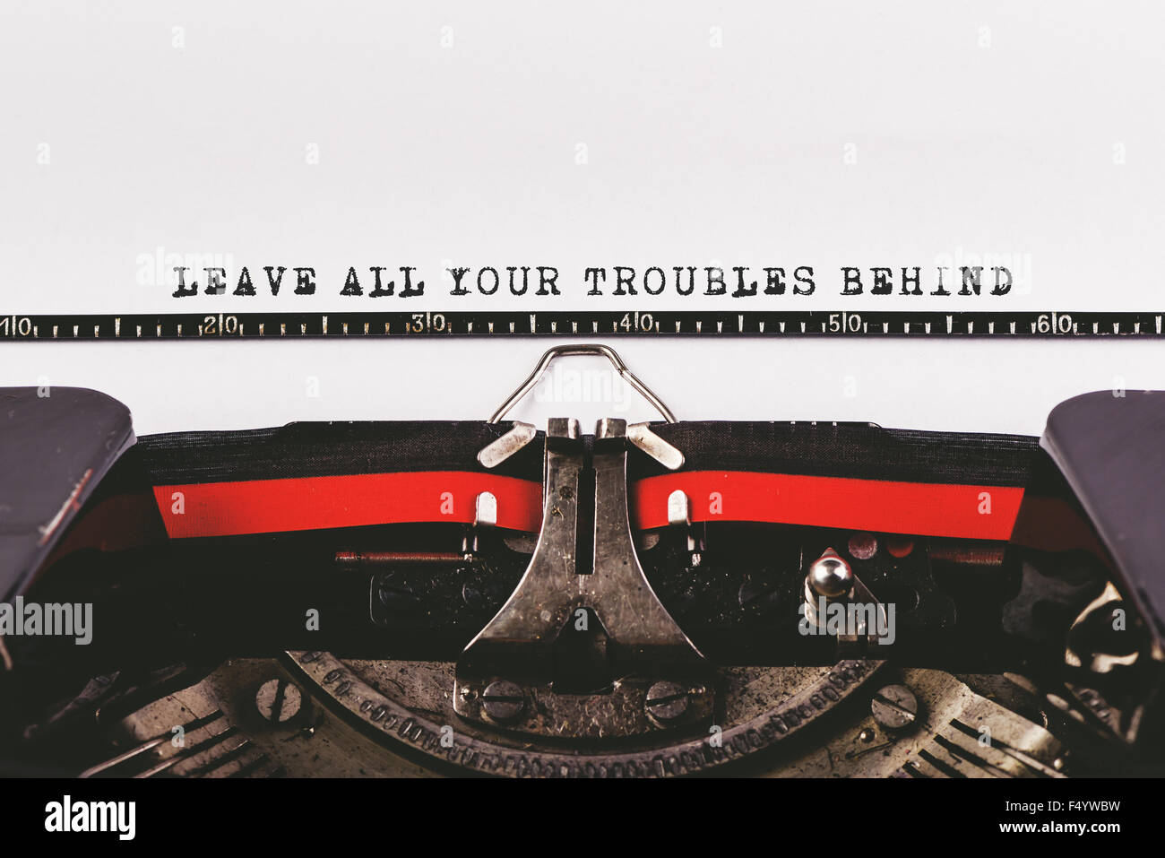 Leave all your troubles behind, motivationl message typed on old typwriter machine Stock Photo