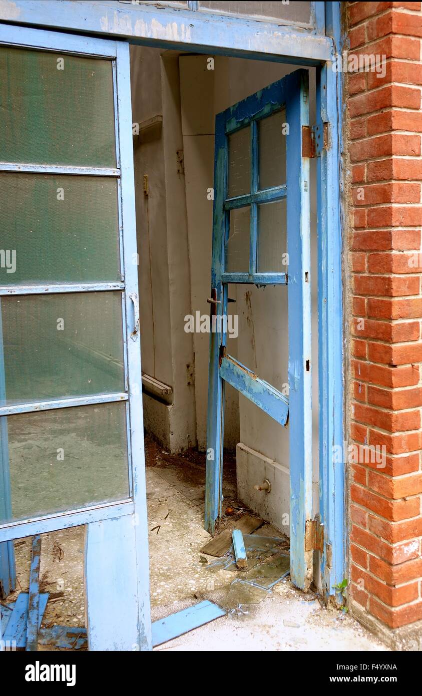 The broken door frame of a dilapidated and deserted building Stock Photo