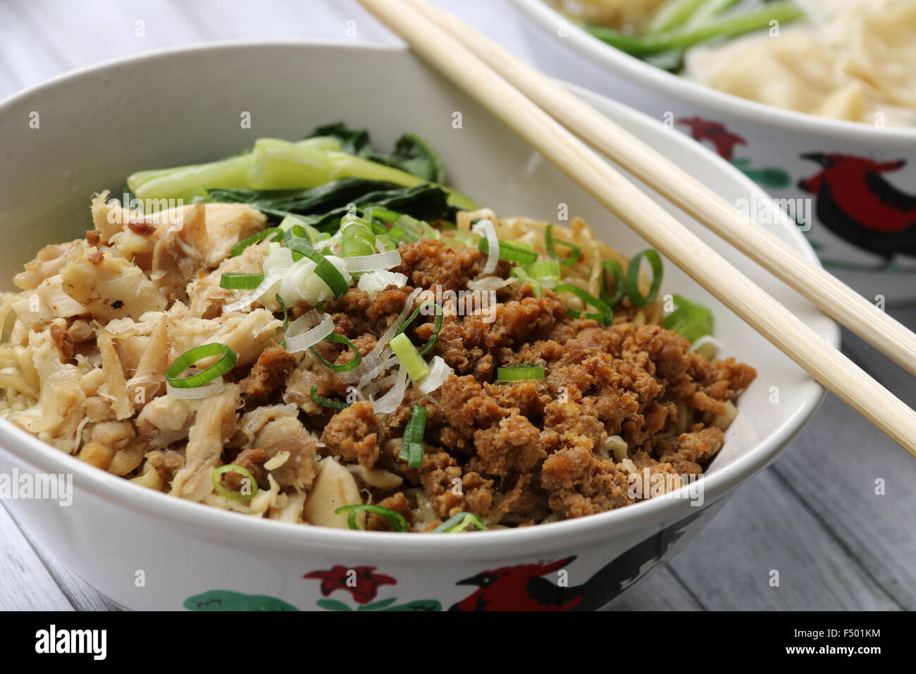 Noodle soup with diced chicken, minced pork, and green vegetable