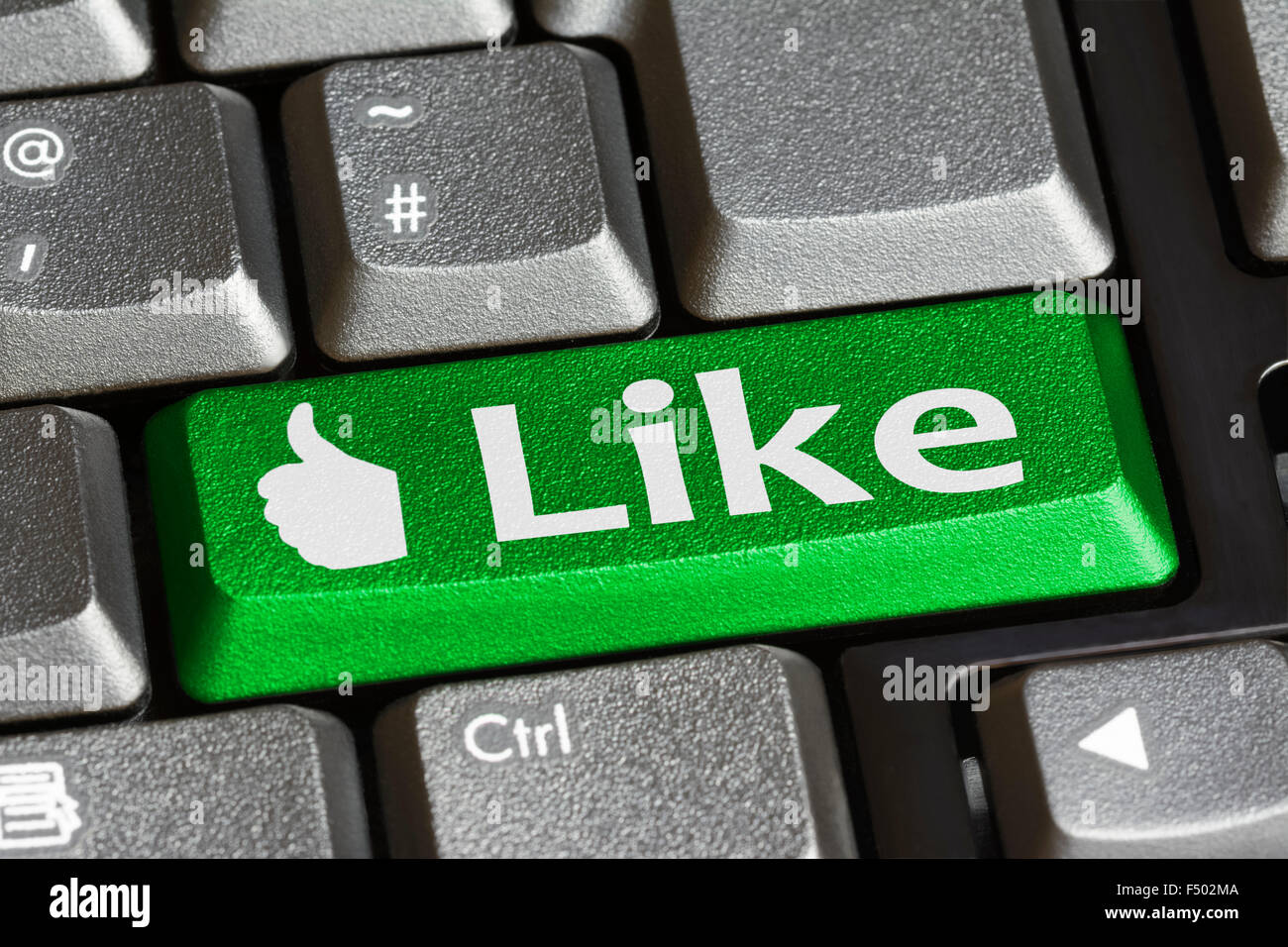 Like button for social networking on a computer keyboard. Like concept. Stock Photo