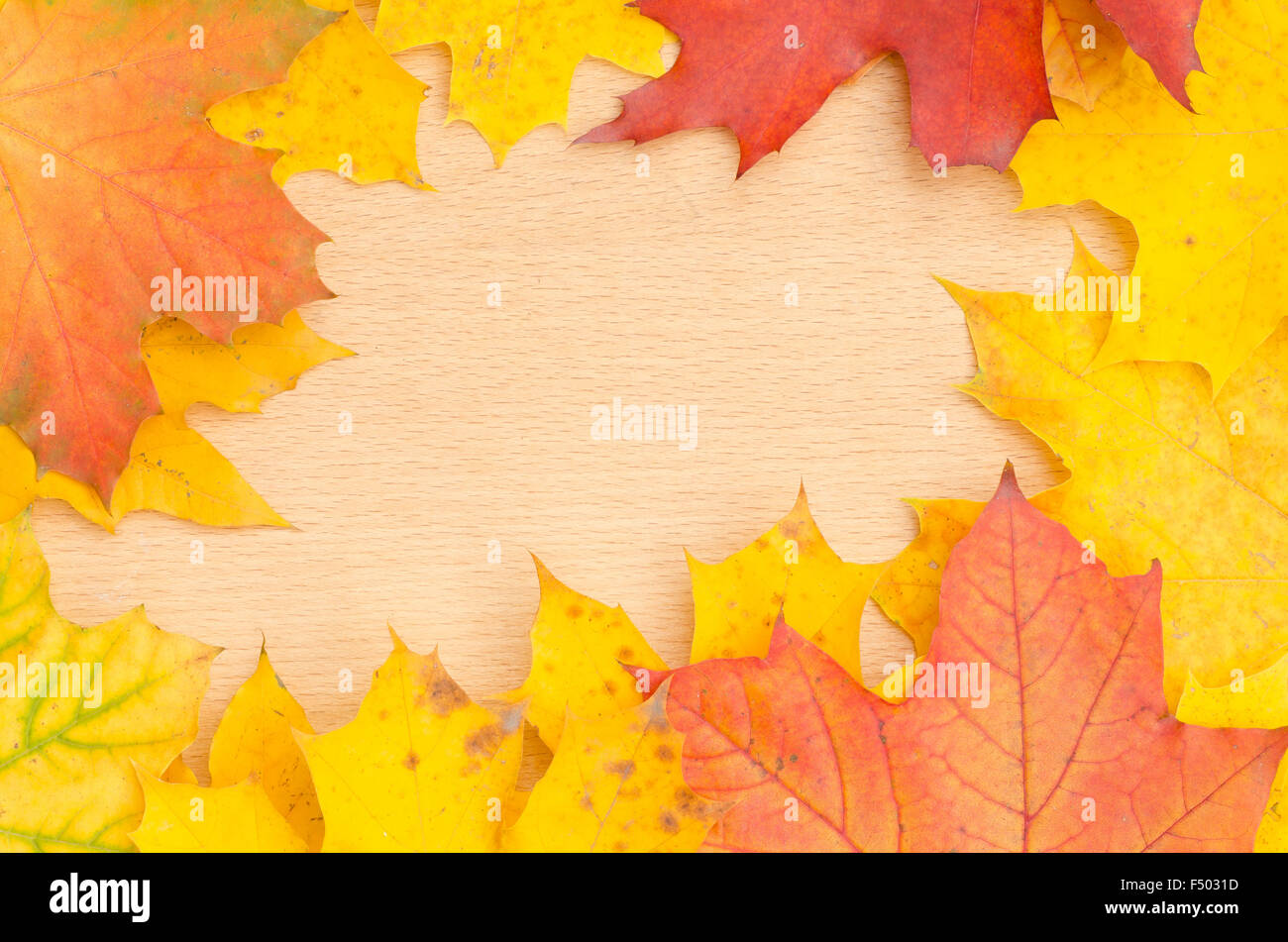 fall leaves frame on wooden background Stock Photo