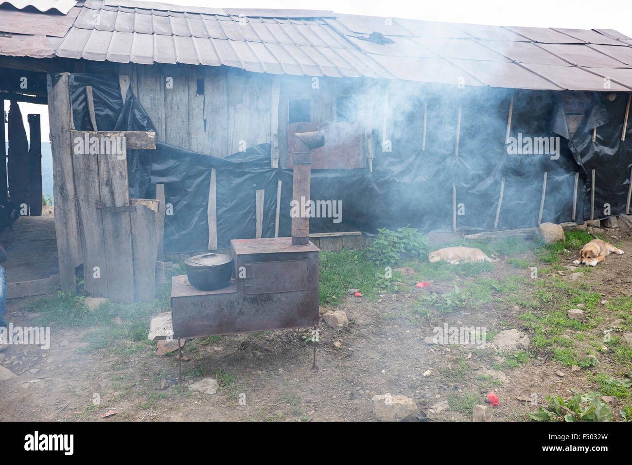 Rustic wood burning stove baking bread outside a ramshackle shepherd