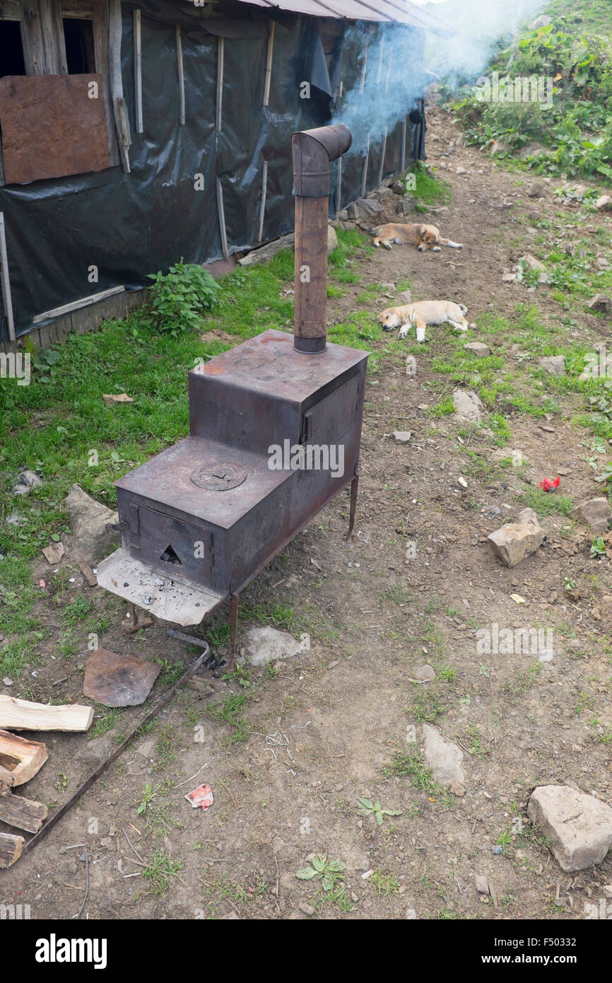 Rustic wood burning stove baking bread outside a ramshackle shepherd