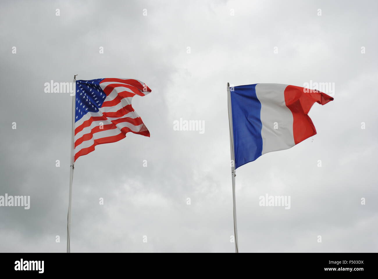 American and French Flags in wind Stock Photo