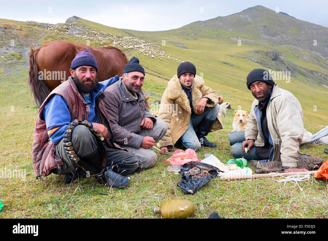 This picture shows four high pasture shepherds eating together. Stock Photo