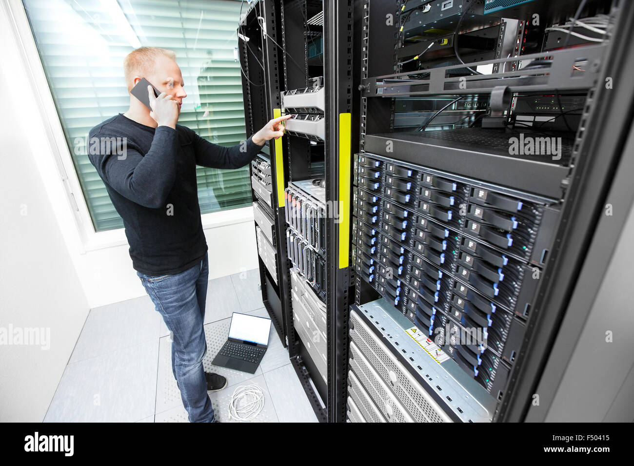 Problem solving IT consultant in datacenter Stock Photo