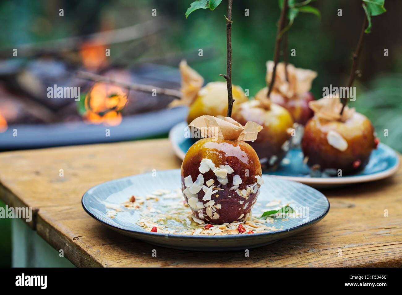 Toffee apples and a bonfire in the background Stock Photo