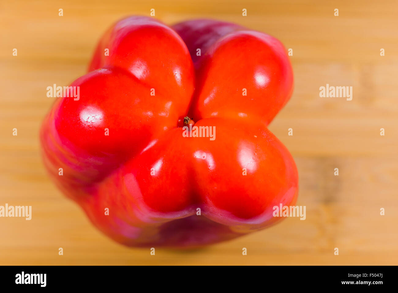 Red bell pepper on wooden table Stock Photo