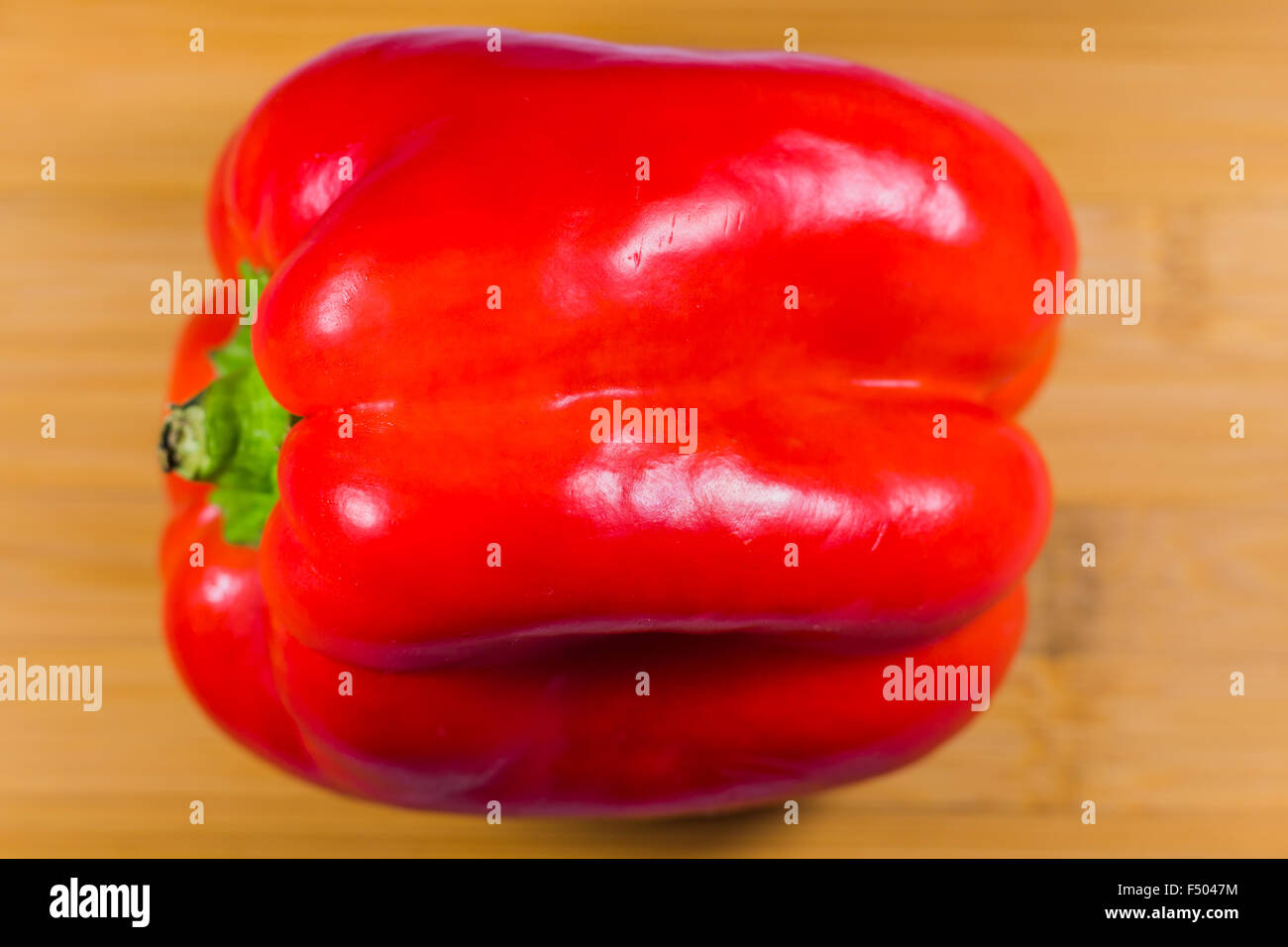 Red bell pepper on wooden table Stock Photo