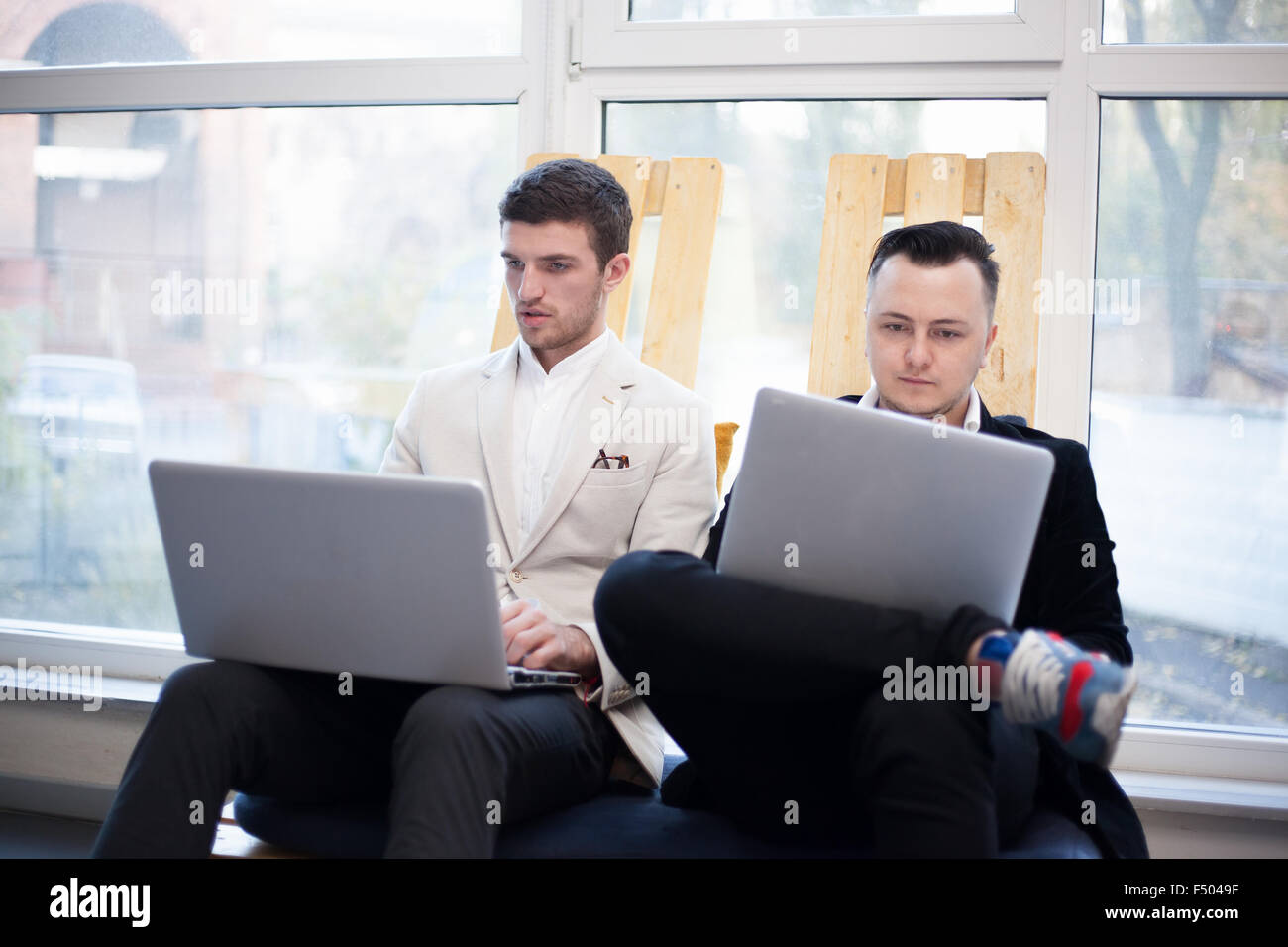 Men using laptops in startup center Stock Photo