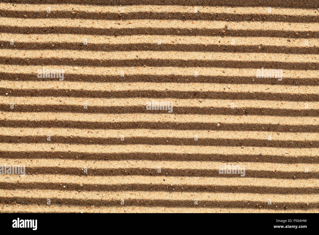 yellow dry sand in stripes as background Stock Photo