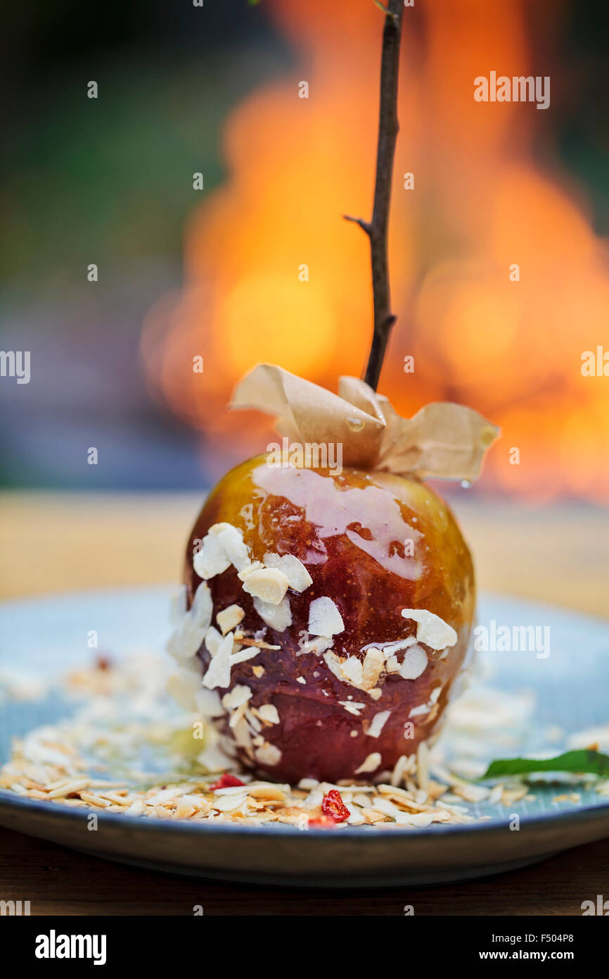 Toffee apples and a bonfire in the background Stock Photo