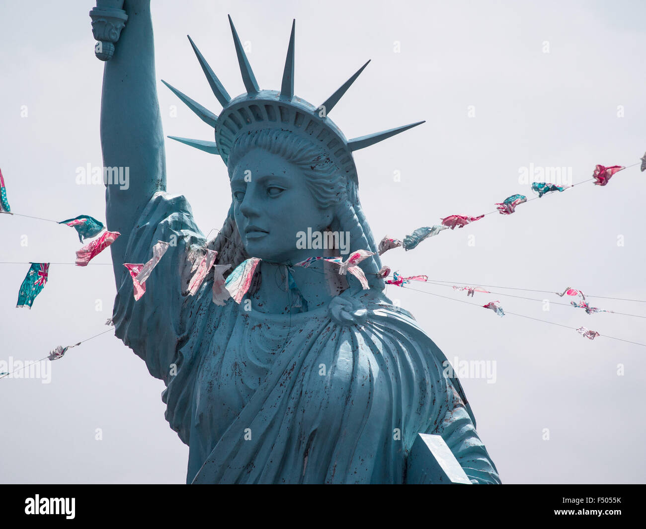 Choking lady liberty ropes wrapped around the neck of a replica of