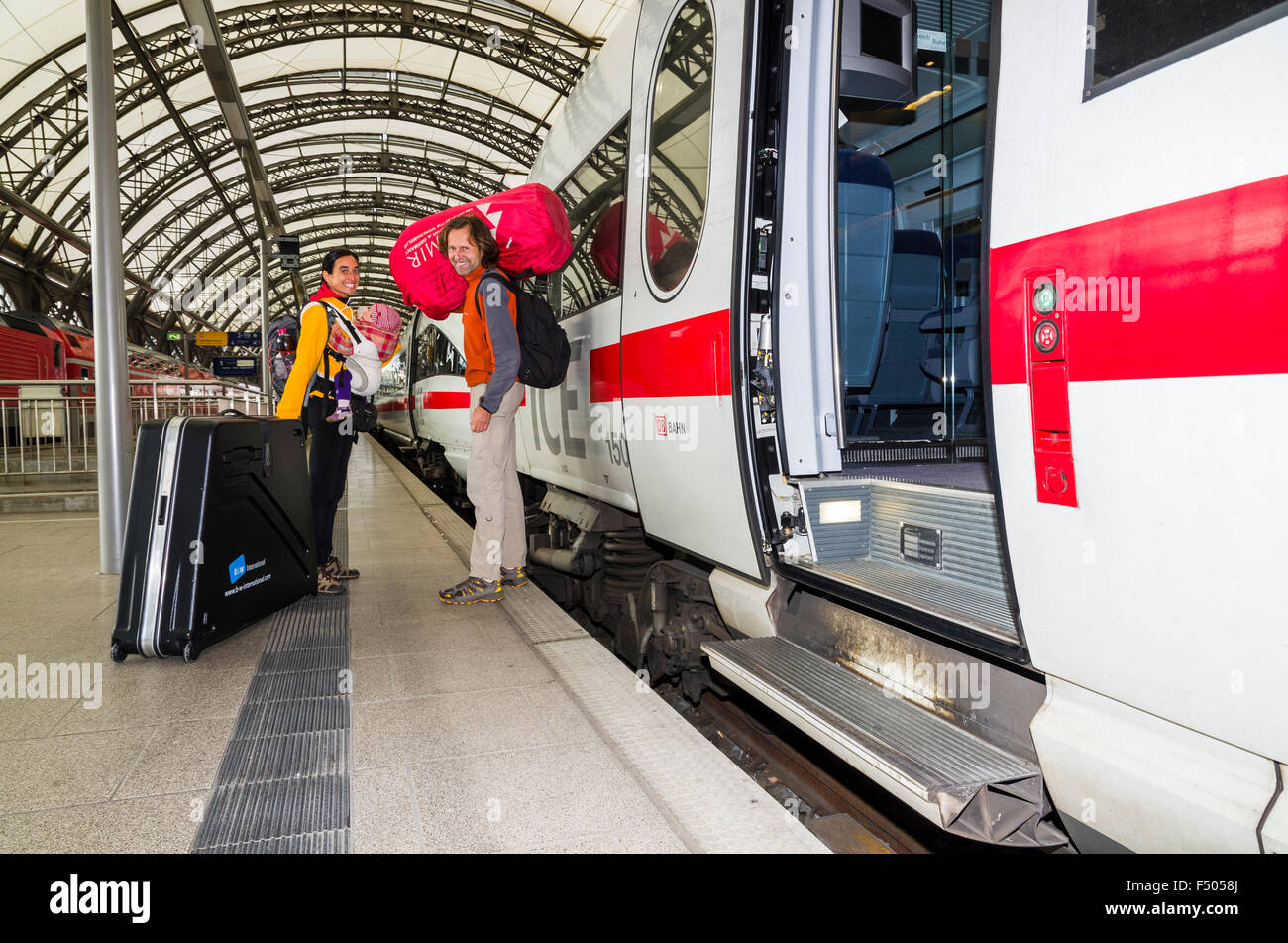 Family with luggage and small child on platform, departing by ICE train