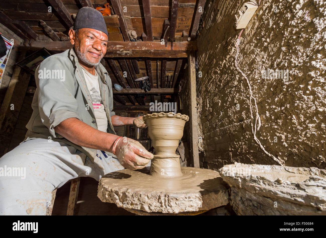 Man making pottery by hand with simple equipment Stock Photo Alamy