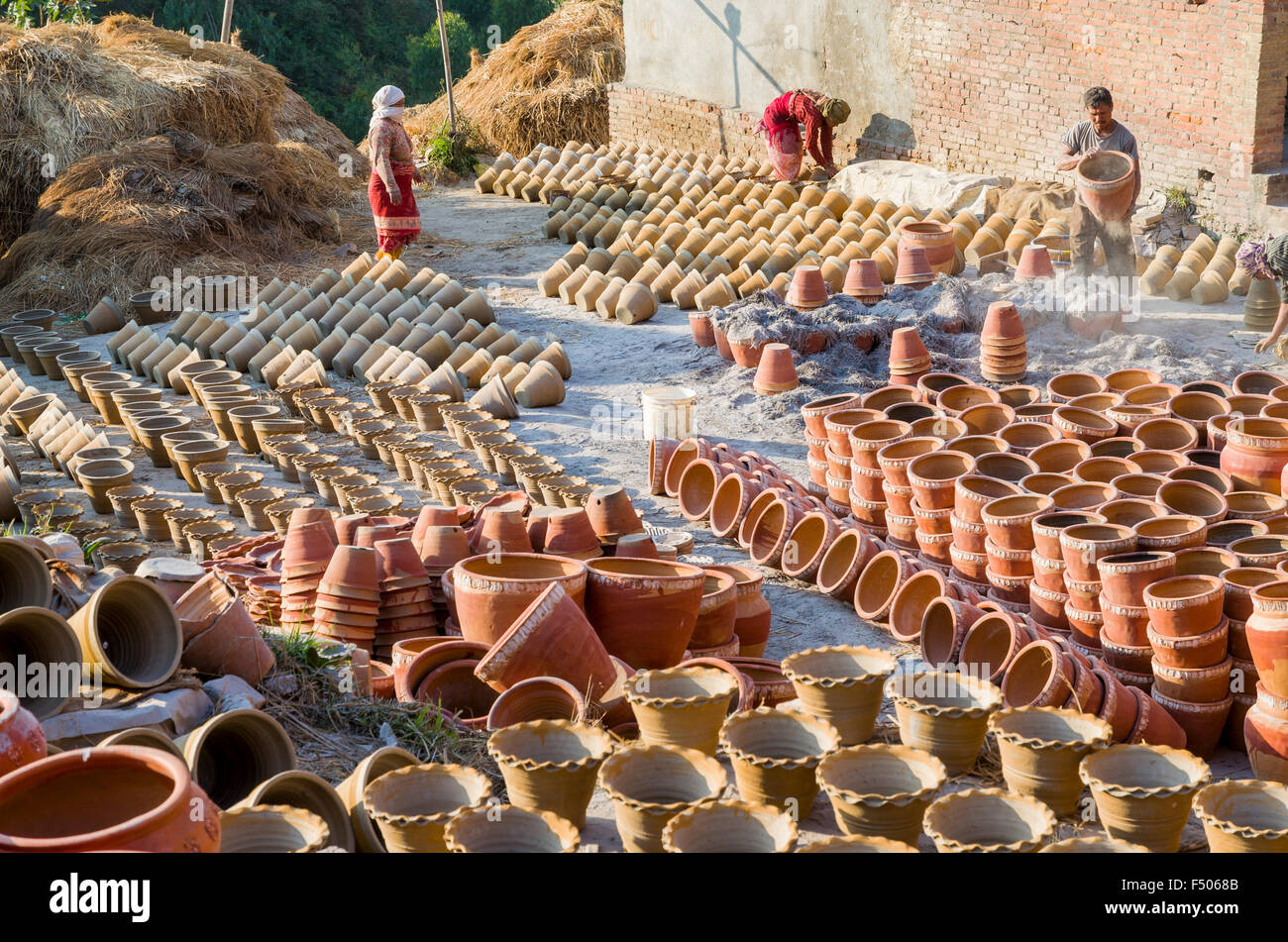 Workers sorting out pottery after the burning process Stock Photo Alamy